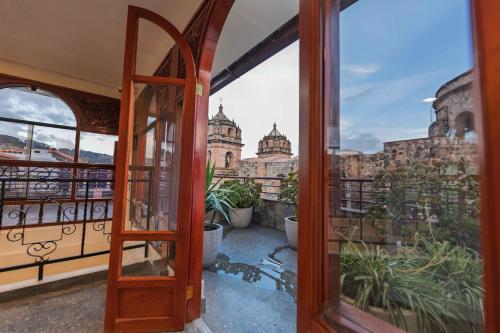 an open door to a balcony with a view of a building at Quechua Hotel Cusco in Cusco