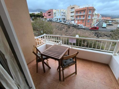 a table and chairs on a balcony with a view at BRISAS DEL MAR Eddy,,AIR,WIFI in Candelaria