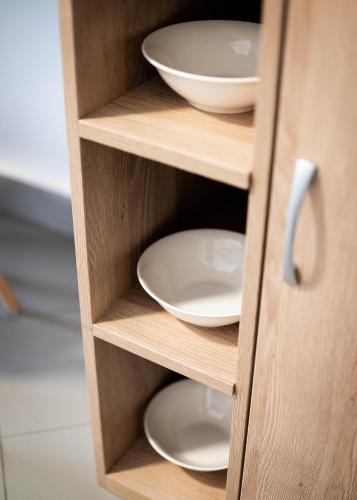 a cupboard with white bowls and plates in it at Studio Apartment Cudo Nevidjeno in Karuč