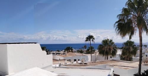 a view of the ocean from a building at Apartamento Via Mare in Puerto del Carmen