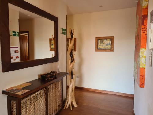 a living room with a mirror and a table at MARGASOL in Pedrezuela