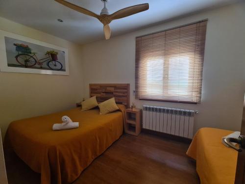 a bedroom with a bed and a ceiling fan at MARGASOL in Pedrezuela
