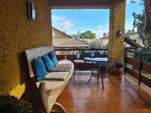a patio with a couch and a table on a balcony at MARGASOL in Pedrezuela