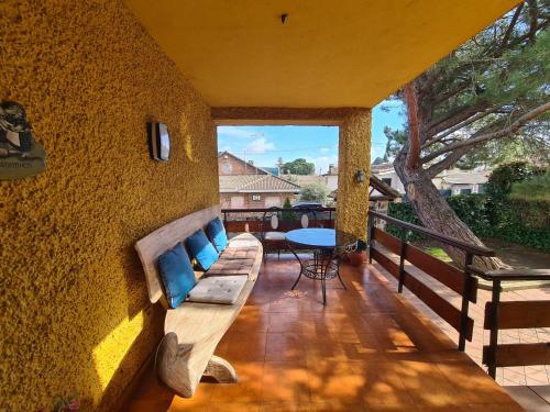 a patio with a couch and a table on a balcony at MARGASOL in Pedrezuela