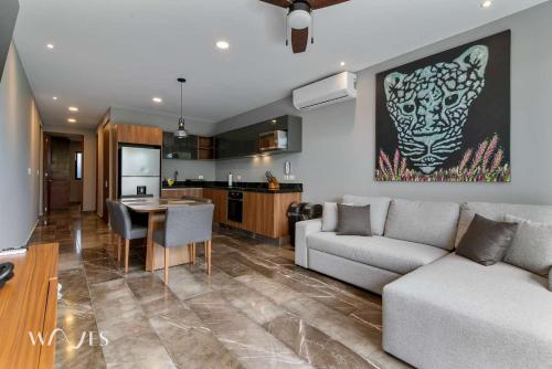 a living room with a couch and a table at Modern 1 Bedroom Apartment with Luxury Amenities at Paramar Black by Waves in Tulum