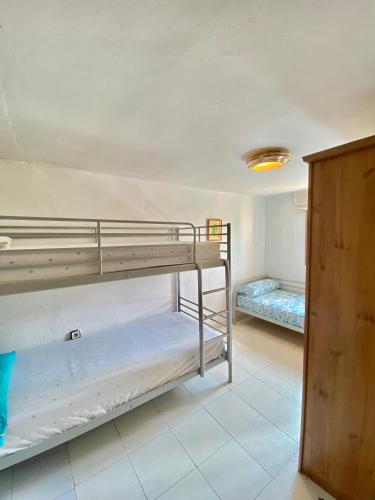 two bunk beds in a room with a ceiling at Casa La Alegria in Maçanet de la Selva