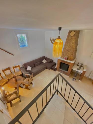 a living room with a couch and a table and a fireplace at Casa La Alegria in Maçanet de la Selva