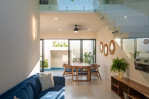a living room with a blue couch and a table at CASA ZOE- Cerca de playa in Puerto Escondido