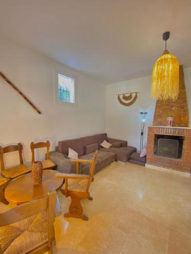 a living room with a couch and a fireplace at Casa La Alegria in Maçanet de la Selva