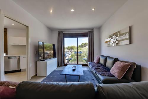 a living room with a couch and a table at Flat 58 - City Center Moraira in Moraira