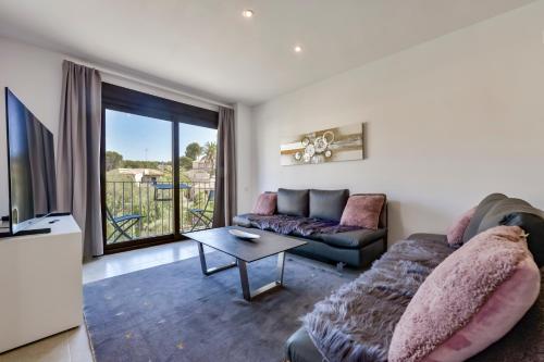 a living room with a couch and a tv at Flat 58 - City Center Moraira in Moraira