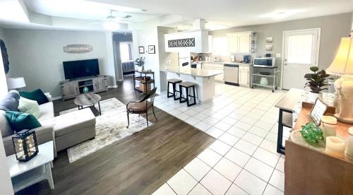 a large living room with a couch and a kitchen at Peaceful Haven 2BR 1BA in Quiet Neighborhood in Nederland