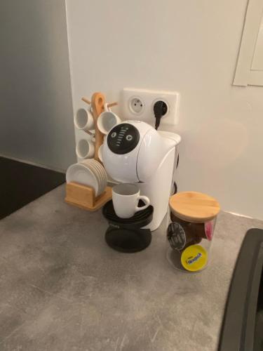 a pretend kitchen with a coffee maker and a stool at Villa Ébène in Cabassou