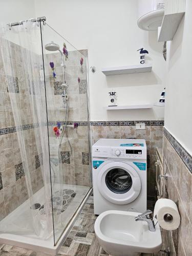 a bathroom with a washing machine and a sink at Una finestra sul mare in Isola delle Femmine