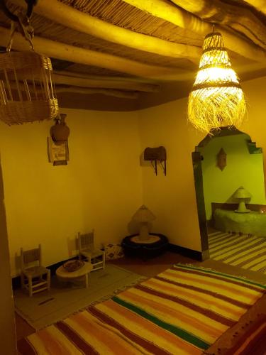 a room with a bedroom with a bed and a ceiling at DAR DANI café restaurant in Boumalne