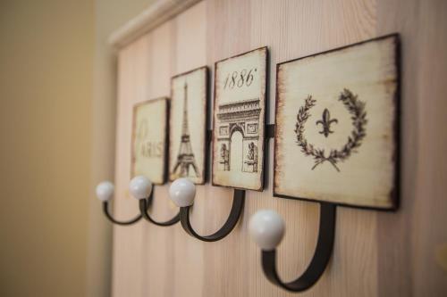 a group of framed pictures hanging on a wall at Hotel Ottaviano in Świnoujście