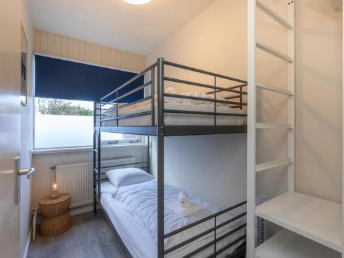 a bunk bed room with two bunk beds in it at Holiday Home in Zoutelande near Sunny Beach in Zoutelande