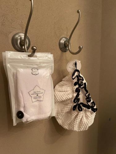 a pair of towels hanging on a wall at Beautiful Penthouse w/amazing View, Prime location in Ramat Gan