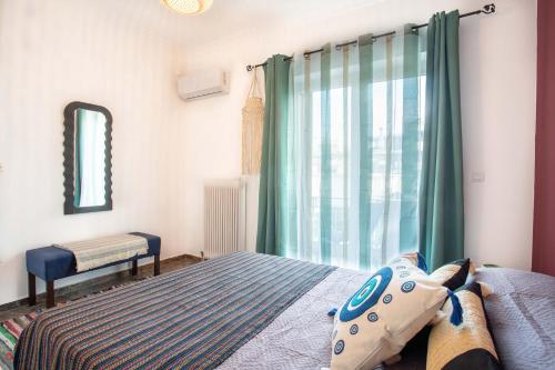 a bedroom with a bed and a window at Κήπος μέ τις πορτοκαλιές in Mytilini