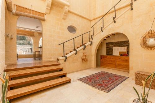 a room with a staircase and a stair case at OneFifty Gozitan Villa and Pool in Il-Pergla