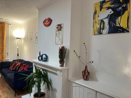 a living room with a couch and a painting on the wall at Private main door Two Bedrooms Apartment in Edinburgh