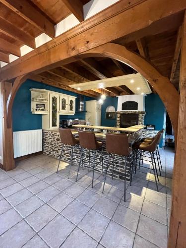 une cuisine avec une table et des chaises dans une pièce dans l'établissement Aux charmes de la campagne, à Millières