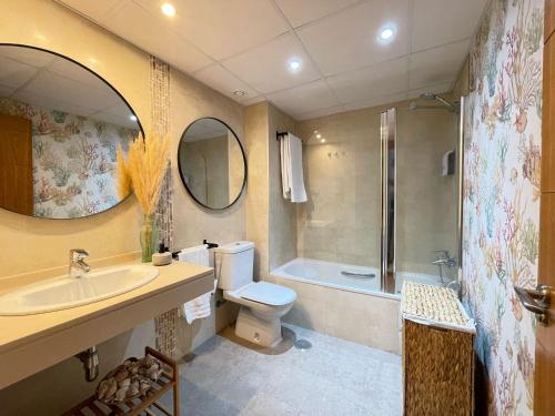 a bathroom with a sink and a toilet and a shower at La casa de Mateo Playa Granada in Motril