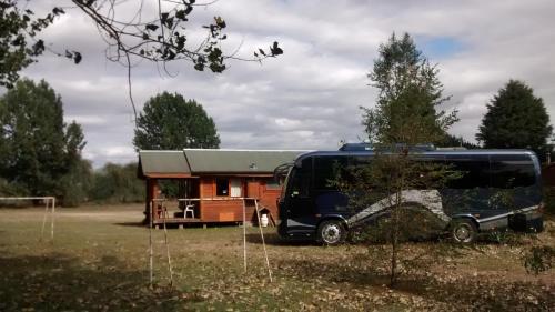 a bus parked in front of a tiny house at Cabañas De Madera in La Unión