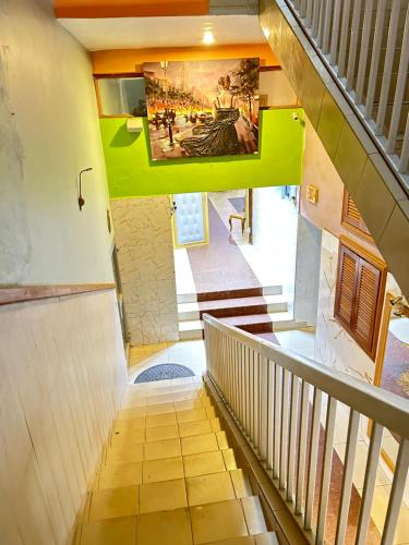 an overhead view of a staircase with a painting on the wall at Eva Hotel in Douala