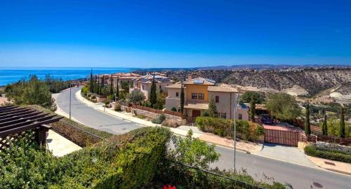 arial view of a street with houses and the ocean at Beautiful Apartment BJ12 with Amazing Sea Views, Aphrodite Hills in Kouklia