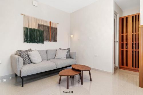 a living room with a couch and a table at Ayana Inn PR in San Juan