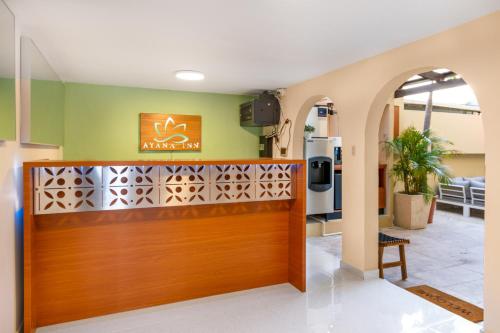 a lobby of a miami inn with a wooden door at Ayana Inn PR in San Juan