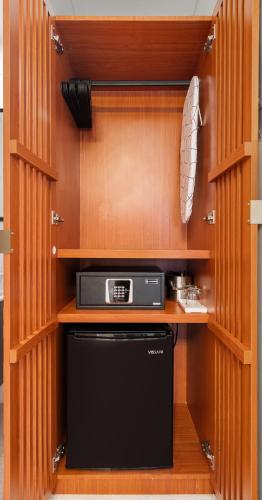 a kitchen with a dishwasher in a wooden cabinet at Ayana Inn PR in San Juan