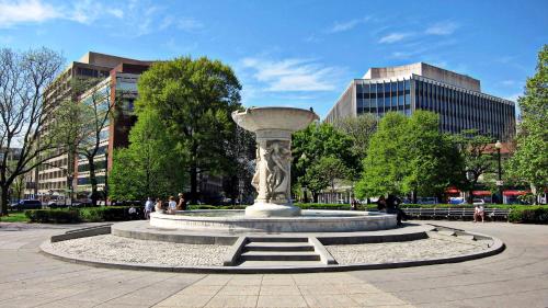 a statue in a park with buildings in the background at Hala DC in Washington