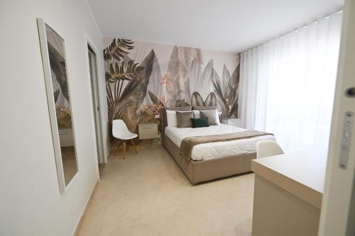 a bedroom with a bed and a mural of plants at Barimare in Bari