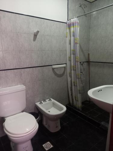 a bathroom with a toilet and a sink at Departamentos Complejo Turístico Cruz Mendoza in Tilcara
