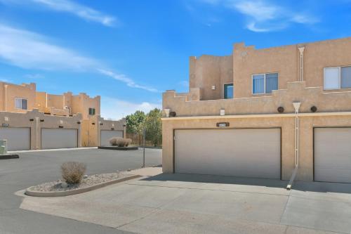 a row of three garages in front of a building at Executive Townhouse To Stay in Colorado Springs