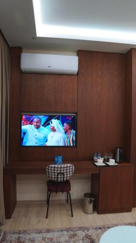 a room with a flat screen tv on a wall at Blue Moon Hotel in Erbil