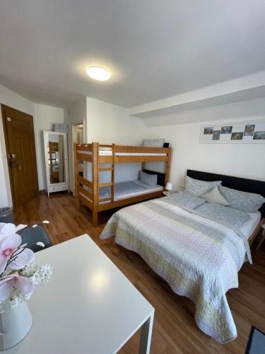 a small bedroom with two beds and a table at House LA Neuschwanstein Blick - Budget City Hotel in Füssen