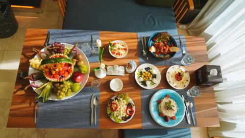 a table with many plates of food on it at Blue Moon Hotel in Erbil