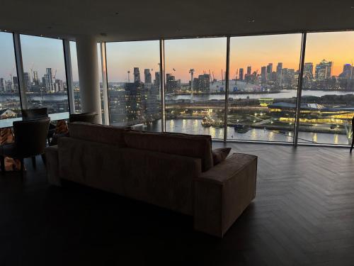 a living room with a couch and a view of the city at Excel Luxury Apartment with amazing view in London