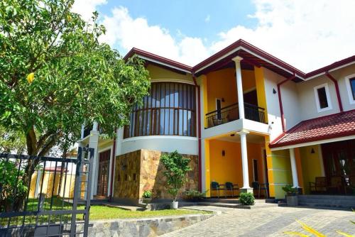 a house with yellow and white at Bigcity Villa - Airport Transit Hotel in Katunayake