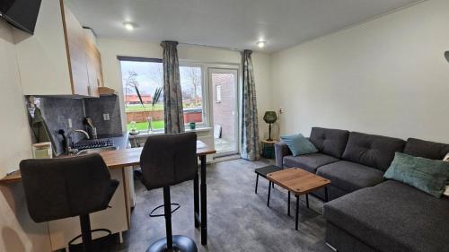 a living room with a couch and a table at B&B MiRo in Rouveen