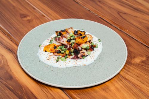 a plate of food on a wooden table at Wao Beach Venao in Playa Venao