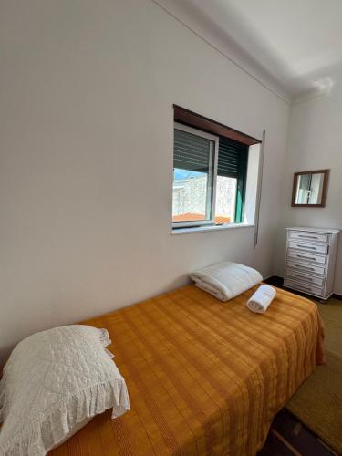 a bedroom with a bed and a window at House Mariona in Caminha