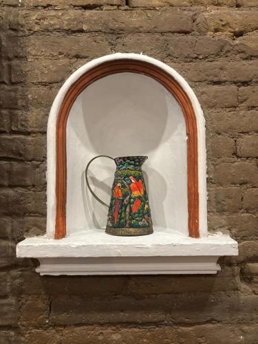 a vase sitting on a shelf in a brick wall at Terraza De San Antonio in Cali