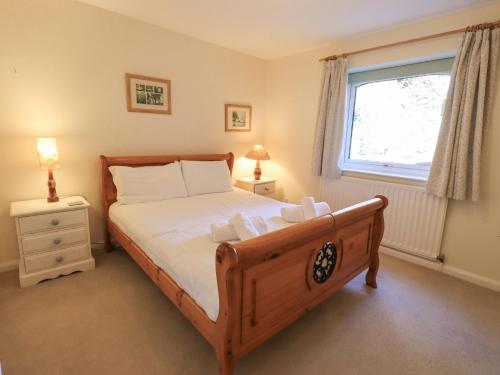 a bedroom with a large bed and a window at Striding Home in Ambleside