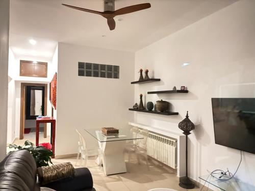 a living room with a couch and a tv and a table at La casita de la Roca in Guadarrama