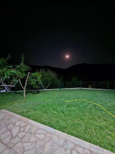 a yard at night with the moon in the sky at Villa Sara in Kratovo
