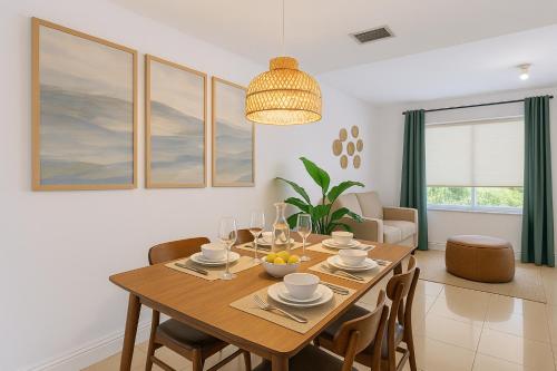 a dining room with a wooden table and chairs at Central Miami Oasis, Near Brickell, Grove & Little Havana in Miami